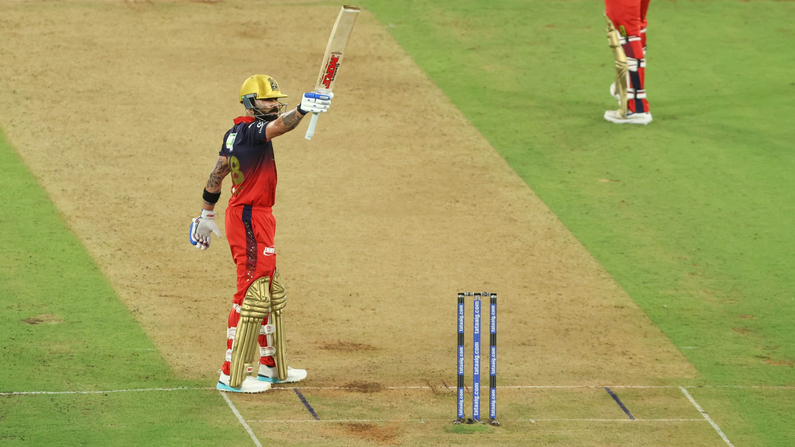 Virat Kohli raises his bat after completing his unbeaten half-century in the IPL 2026 Final at Narendra Modi Stadium, Ahmedabad